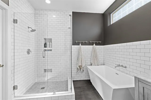 a bathroom with a bathtub and shower