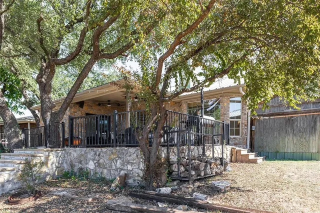a view of a house with a tree in the yard