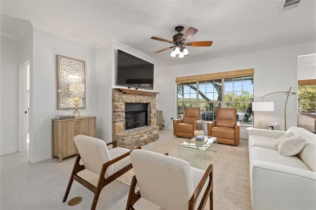 a living room with furniture a fireplace and a flat screen tv