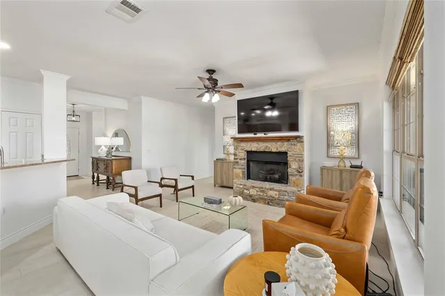 a living room with furniture a fireplace and a flat screen tv