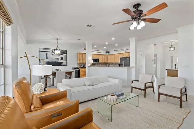 a living room with furniture and a view of kitchen