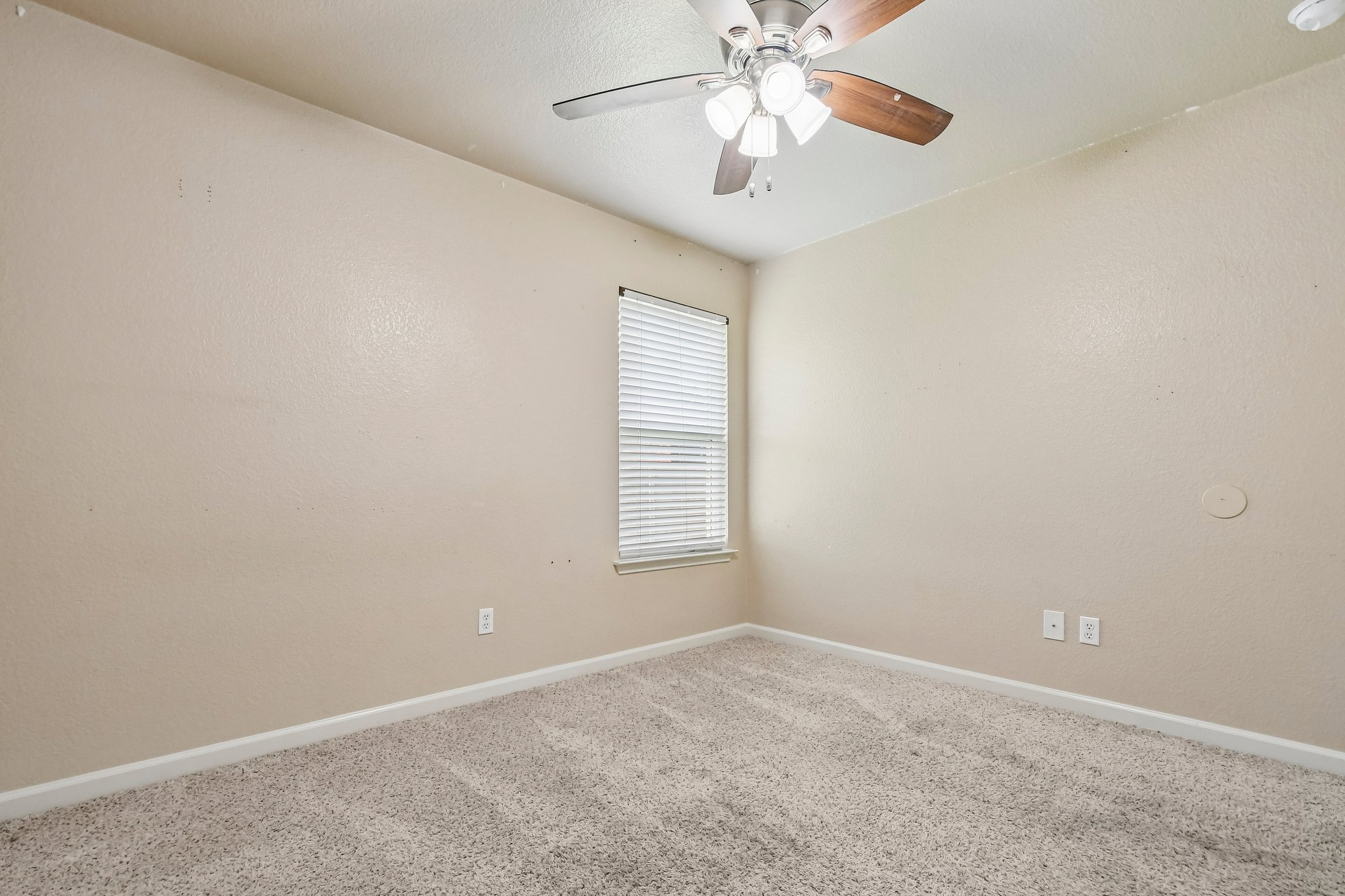 125 Mason Reed Cove Kyle, TX 78640 - Photo 26 of 39 an empty room with a chandelier fan and windows