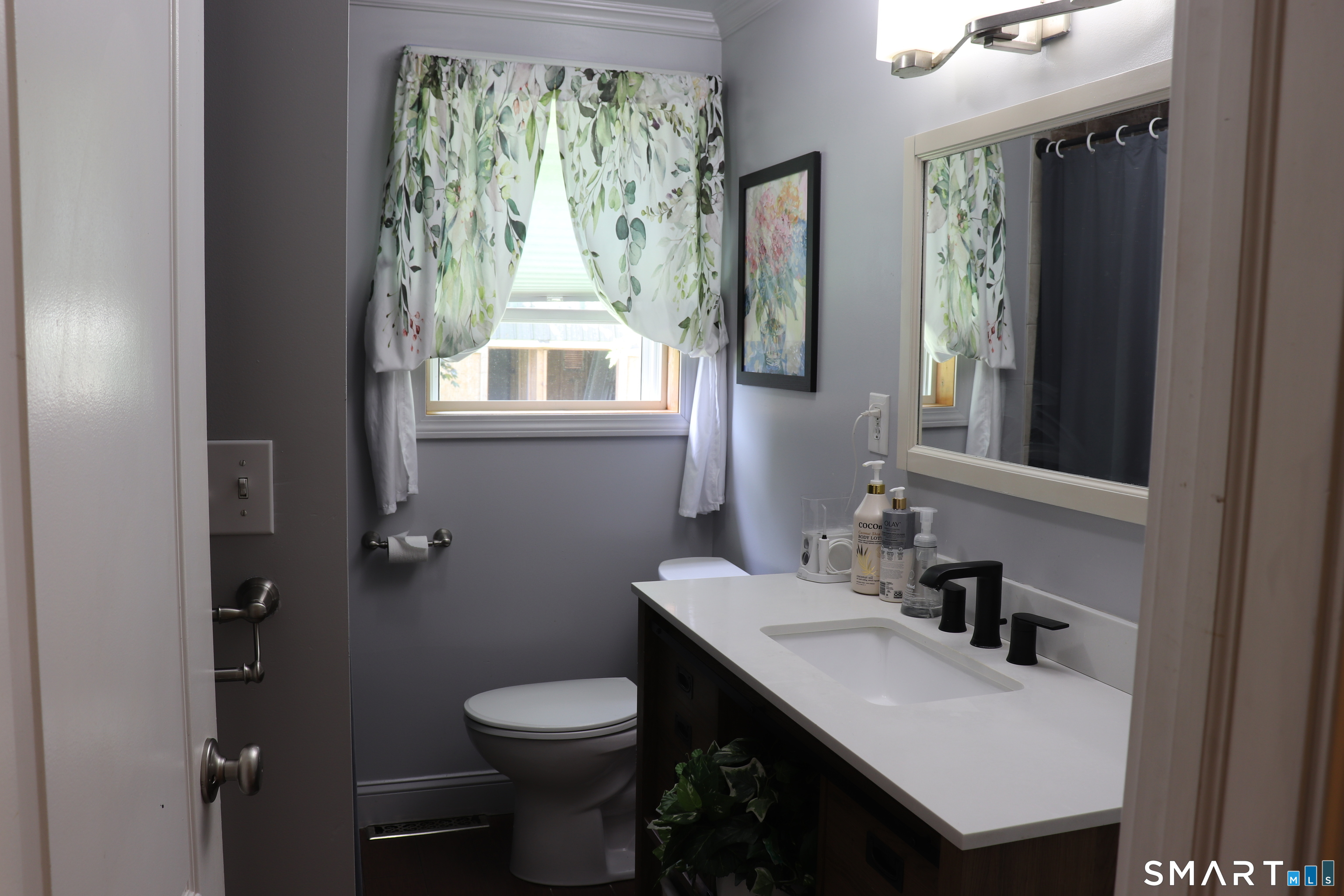 308 Abbe Road Enfield, CT 06082 - Photo 17 of 33 a bathroom with a toilet a sink and a mirror