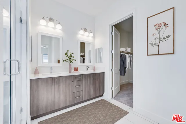 a spacious bathroom with a double vanity sink and a mirror