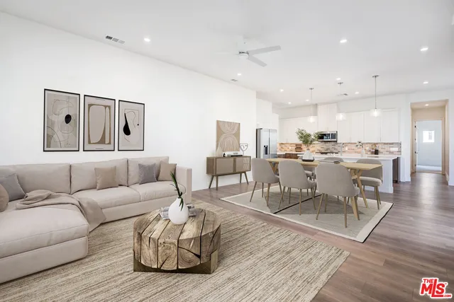 a living room with lots of furniture and wooden floor