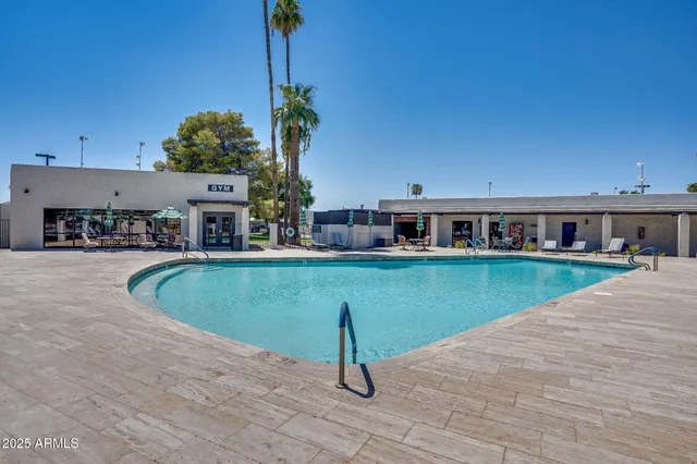 a view of house with outdoor space and swimming pool