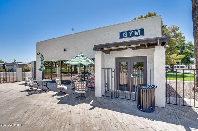 a view of a patio with table and chairs potted plants with wooden fence