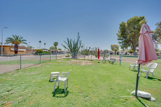 a swimming pool with outdoor seating and yard