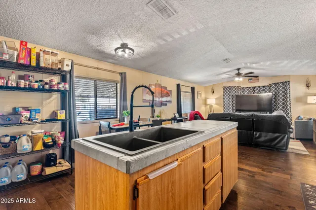 a view of living room kitchen with furniture and a window