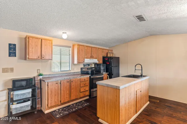 a kitchen with a sink stove and cabinets