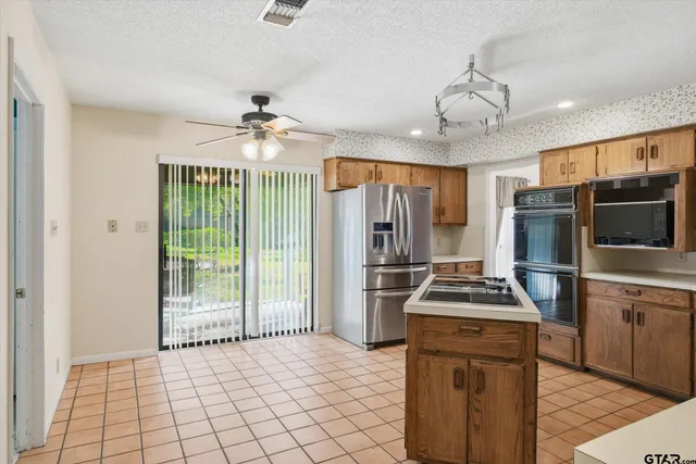 a kitchen with stainless steel appliances a stove a sink and a refrigerator