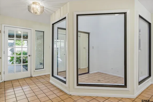 a view of a hallway with wooden floor and dining room