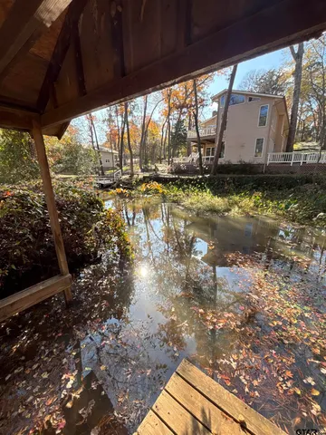 a view of a house with a yard and sitting area