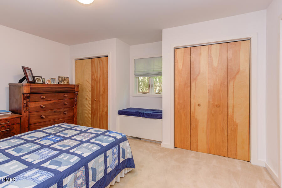 107A Spring Valley Road Carrboro, NC 27510 - Photo 24 of 37 Bedroom on the main floor with its cozy window seat and double closets.