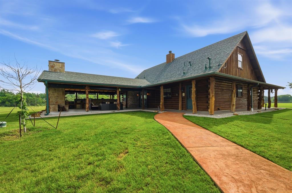 465 Emberson Ranch Road Pilot Point, TX 76258 - Photo 28 of 40 a view of a house with a yard