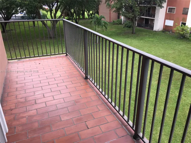 a bathroom with a granite countertop bathtub shower sink vanity and toilet