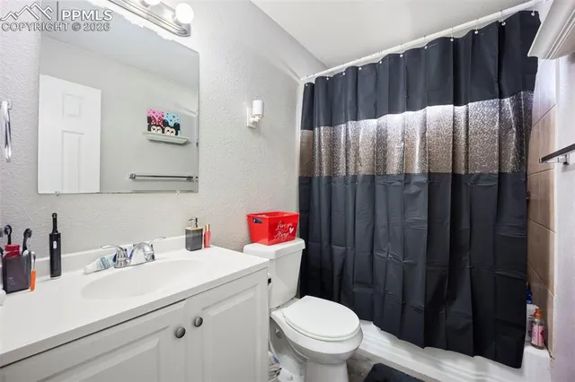 a bathroom with a sink vanity mirror and toilet