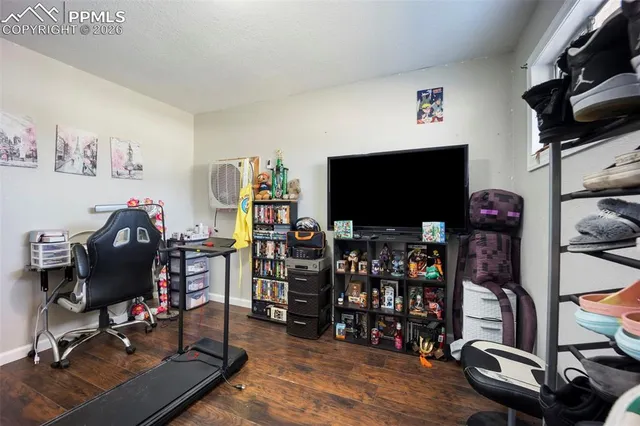 a room with lots of wooden furniture and a flat screen tv