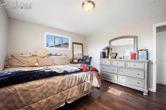 a bedroom with a bed and a dresser