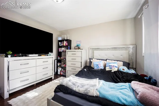 a bedroom with a bed and flat screen tv