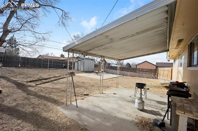 a view of a backyard with table and chairs