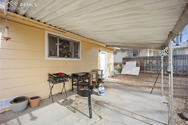 a view of a patio with table and chairs and potted plants