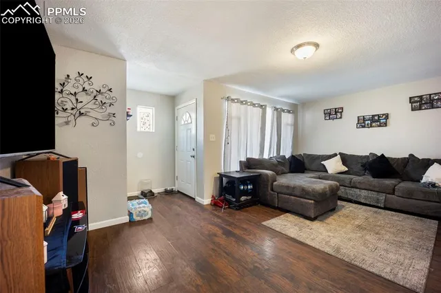 a living room with furniture a couch and dresser