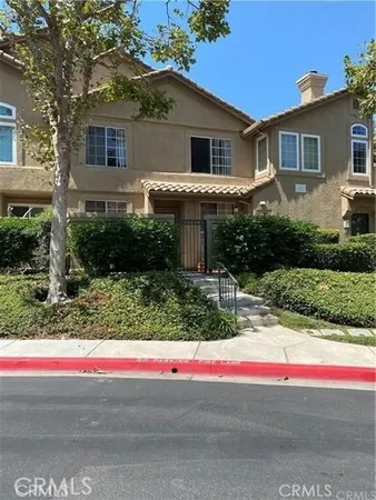 a house that has a tree in front of it