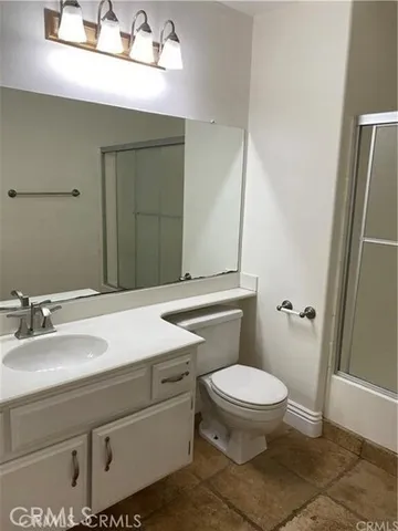 a bathroom with a sink a toilet a mirror and vanity