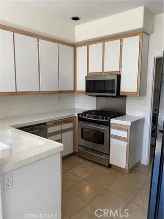 a kitchen with a stove and a microwave