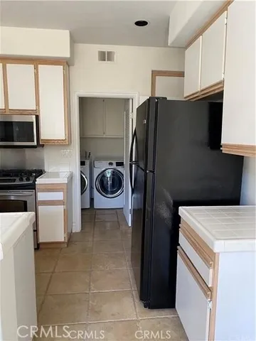 a kitchen with a refrigerator and a stove