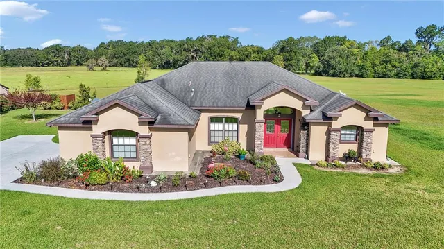 a front view of house with yard and green space
