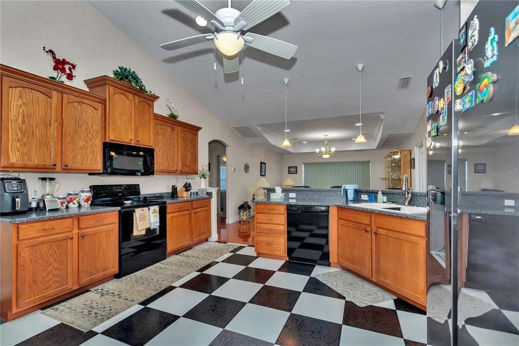 1671 West Highway 316 Citra, FL 32113 - Photo 11 of 46 a kitchen with stainless steel appliances kitchen island granite countertop a sink and cabinets
