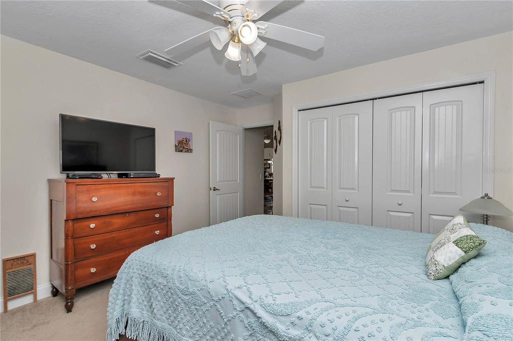 1671 West Highway 316 Citra, FL 32113 - Photo 20 of 46 a bedroom with a bed and a flat screen tv