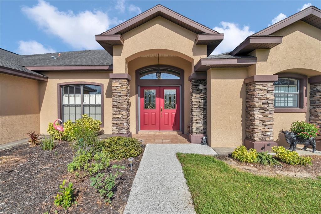 1671 West Highway 316 Citra, FL 32113 - Photo 2 of 46 a front view of a house with garden