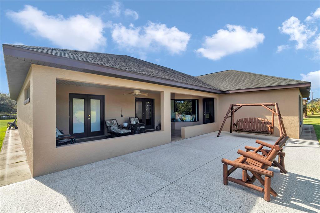 1671 West Highway 316 Citra, FL 32113 - Photo 26 of 46 a living room with furniture and a chandelier