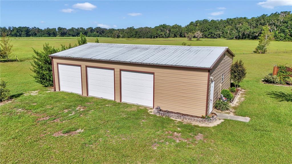 1671 West Highway 316 Citra, FL 32113 - Photo 30 of 46 a view of a backyard with a lake view