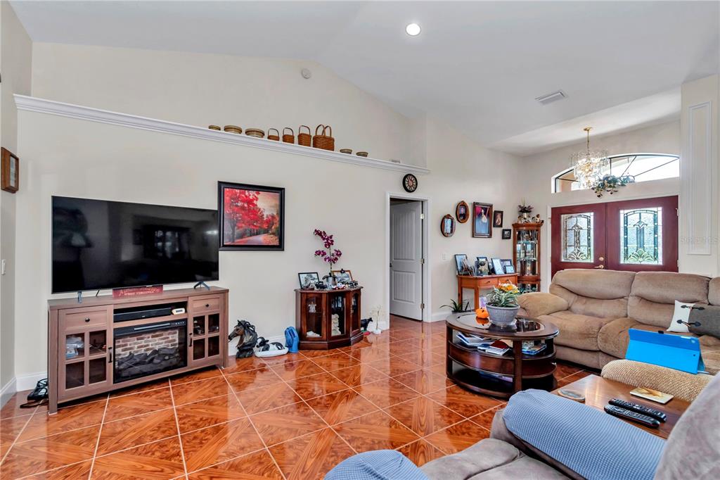 1671 West Highway 316 Citra, FL 32113 - Photo 3 of 46 a living room with furniture and a flat screen tv