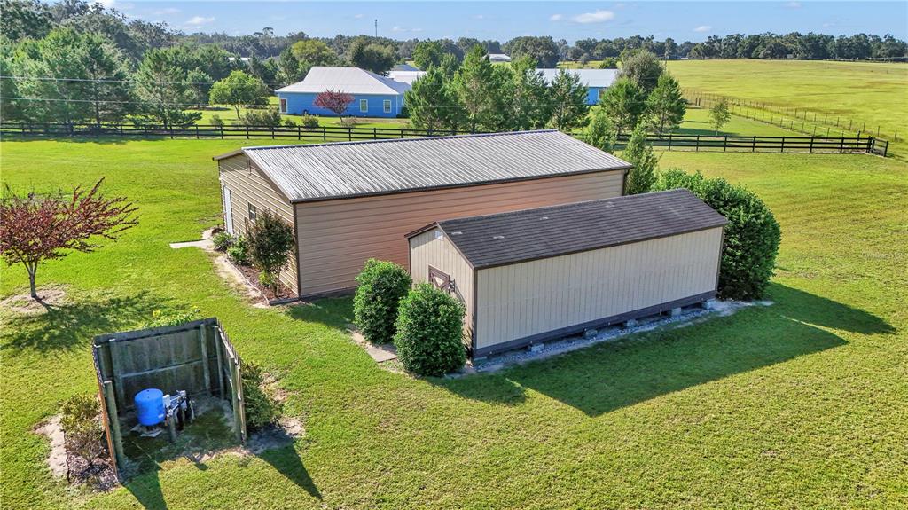 1671 West Highway 316 Citra, FL 32113 - Photo 33 of 46 a aerial view of a house with a garden and lake view