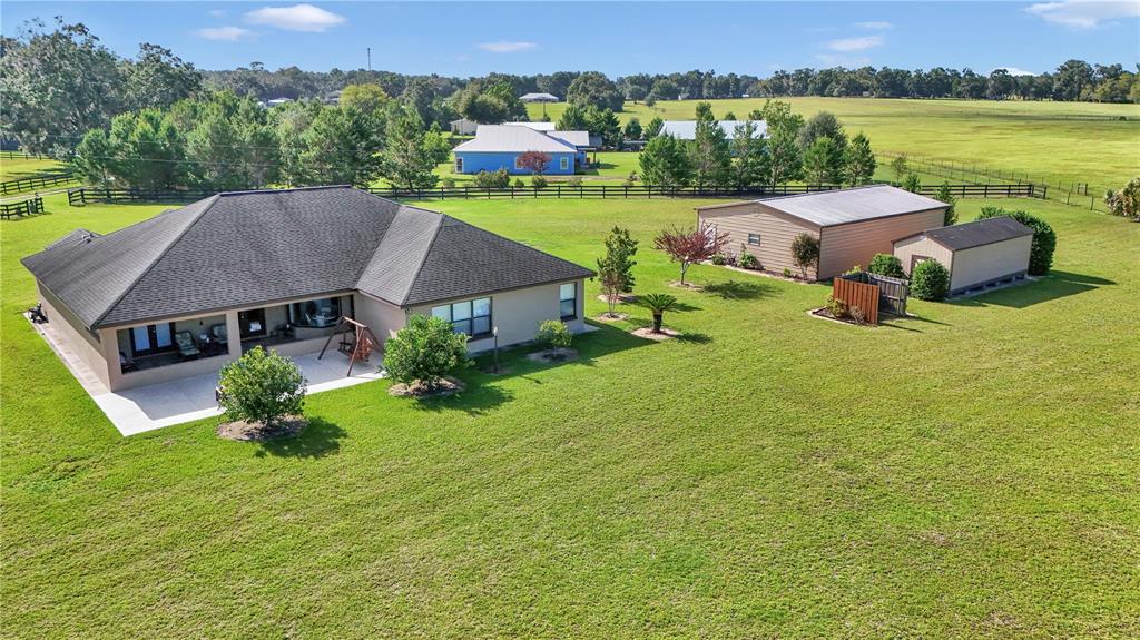1671 West Highway 316 Citra, FL 32113 - Photo 42 of 46 an aerial view of a house with swimming pool garden and lake view