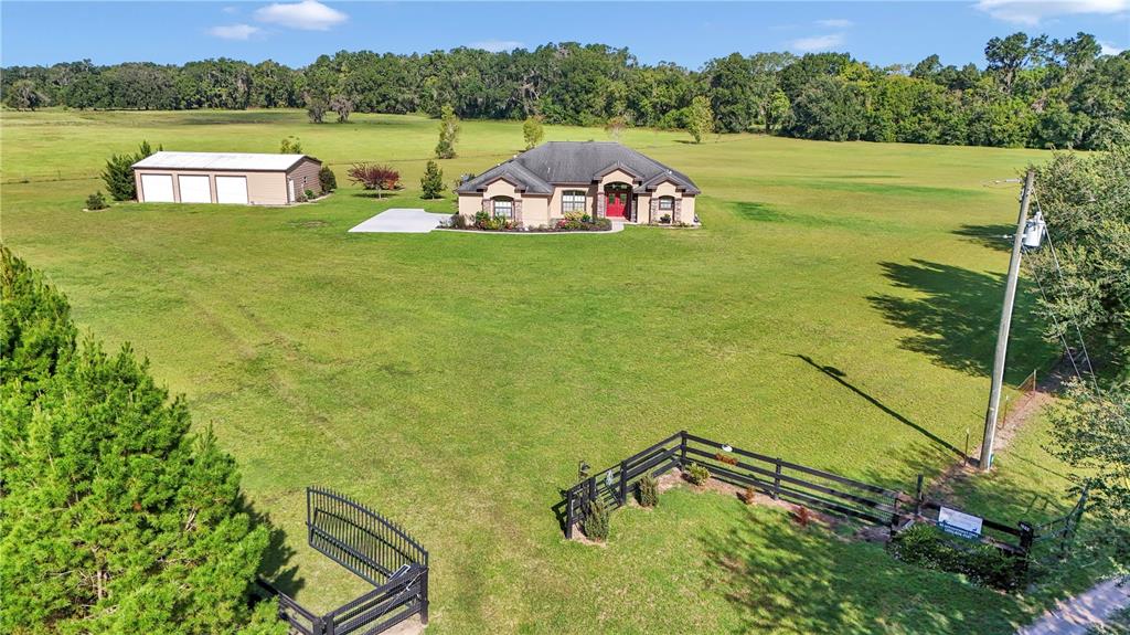 1671 West Highway 316 Citra, FL 32113 - Photo 45 of 46 a view of a lake with a yard and a large window