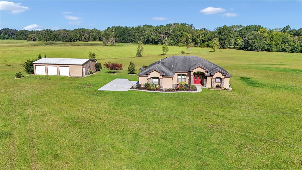 1671 West Highway 316 Citra, FL 32113 - Photo 46 of 46 a view of a lake with a yard and large trees