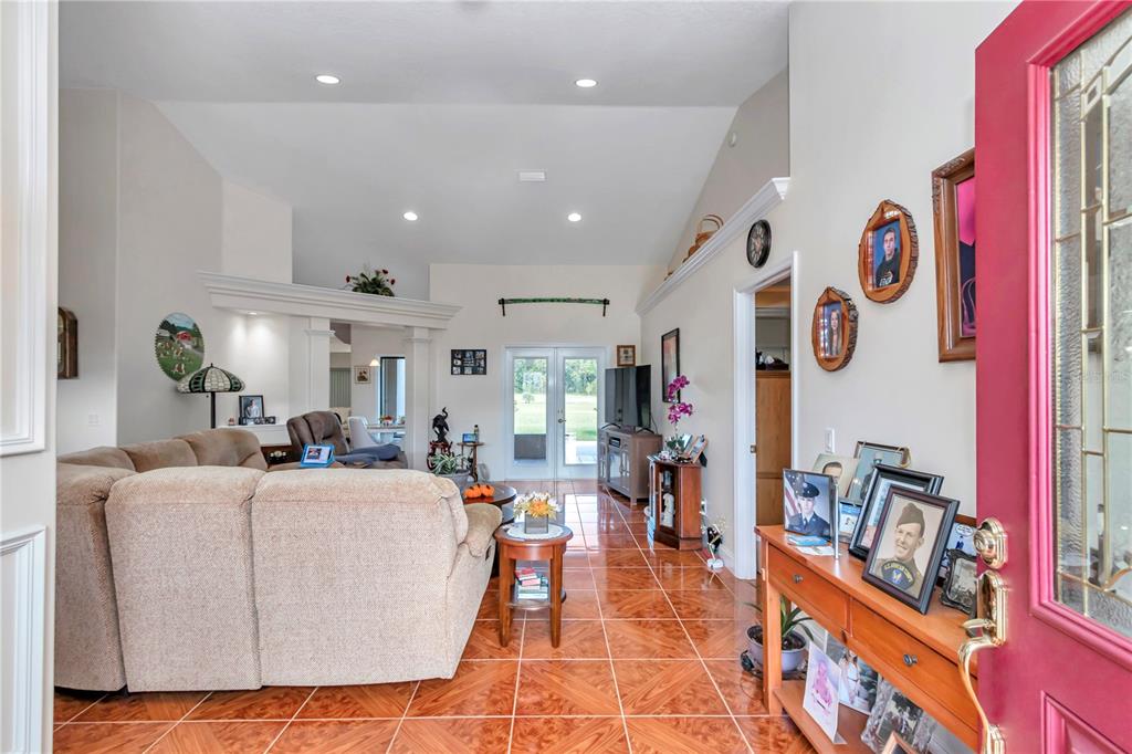 1671 West Highway 316 Citra, FL 32113 - Photo 5 of 46 a living room with lots of furniture and gym equipment