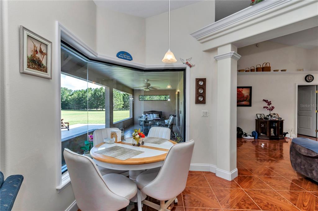1671 West Highway 316 Citra, FL 32113 - Photo 9 of 46 a view of a dining room with furniture window and outside view