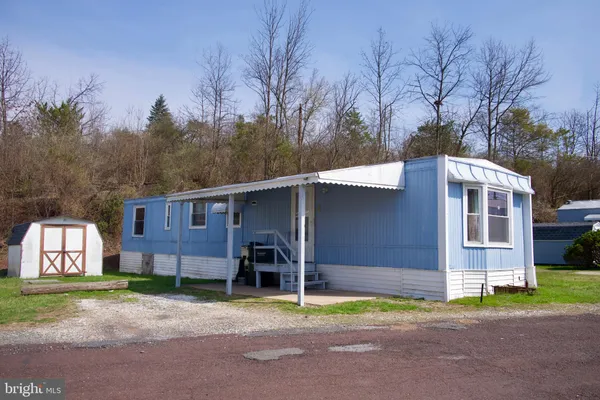 a backyard of a house with barbeque oven and a stove