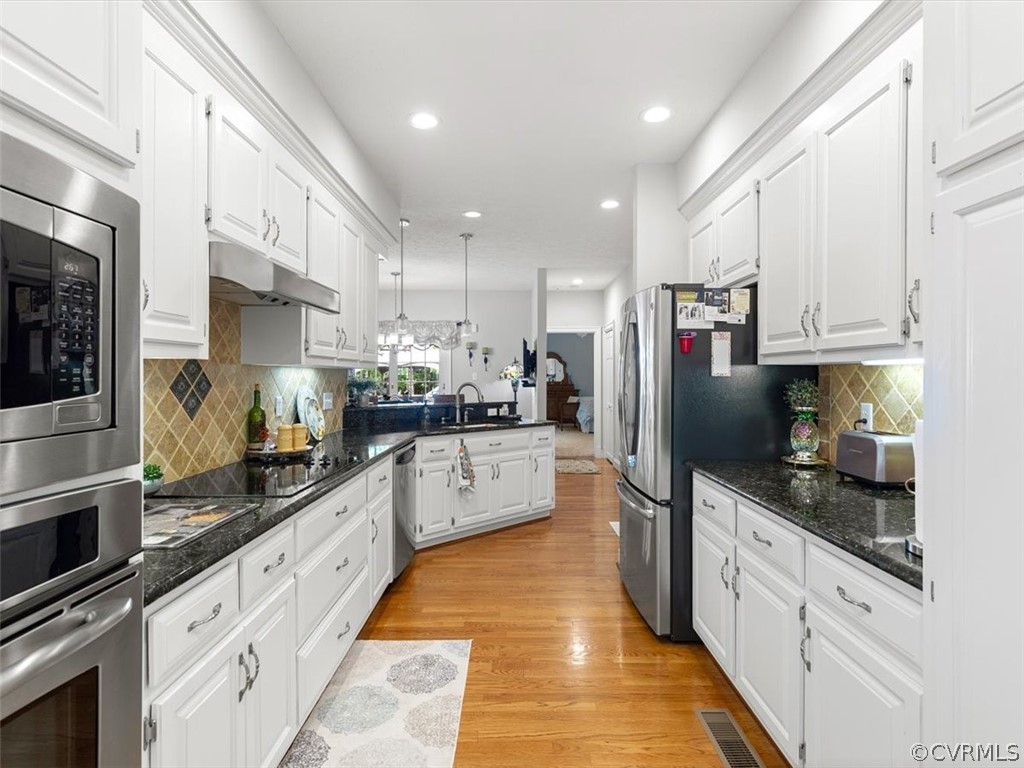 13030 River Road Chesterfield, VA 23838 - Photo 21 of 50 a large kitchen with stainless steel appliances kitchen island granite countertop a large counter top stainless steel appliances and cabinets