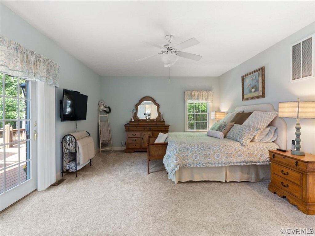13030 River Road Chesterfield, VA 23838 - Photo 25 of 50 a spacious bedroom with a bed and a flat tv screen on the dresser