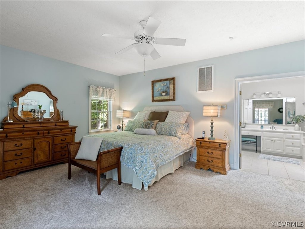 13030 River Road Chesterfield, VA 23838 - Photo 26 of 50 a bedroom with a bed and a chandelier