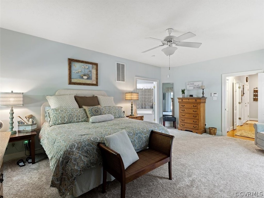 13030 River Road Chesterfield, VA 23838 - Photo 27 of 50 a spacious bedroom with a bed a couch and a chandelier