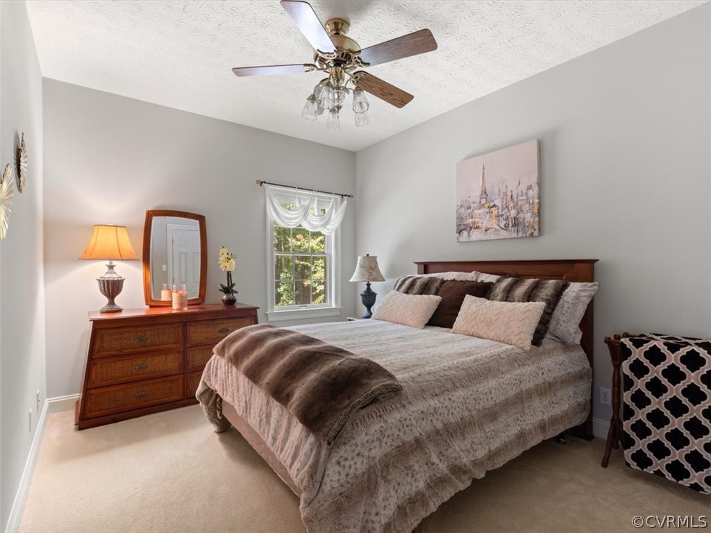 13030 River Road Chesterfield, VA 23838 - Photo 33 of 50 a bedroom with a bed and a chandelier